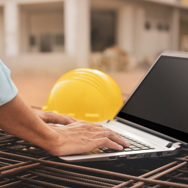 Close-Up Construction Worker Using Procore Sharepoint Bi On Building Site